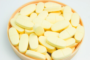A pile of calcium and vitamin D supplement tablets. Isolated