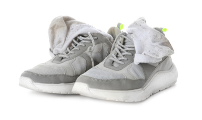Sneakers with dirty socks on white background - obrazy, fototapety, plakaty
