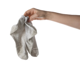 Woman holding dirty socks on white background, closeup