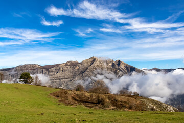 Panoramic view from Monte Comune on cloud covered peaks of Monte Molare, Canino, Caldare in Lattari Mountains, Apennines, Amalfi Coast, Italy, Europe. Hiking trail near the coastal town Positano.