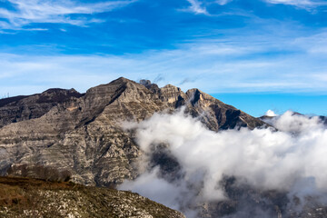 Panoramic view from Monte Comune on cloud covered peaks of Monte Molare, Canino, Caldare in Lattari Mountains, Apennines, Amalfi Coast, Italy, Europe. Hiking trail near the coastal town Positano.
