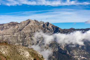 Panoramic view from Monte Comune on cloud covered peaks of Monte Molare, Canino, Caldare in Lattari Mountains, Apennines, Amalfi Coast, Italy, Europe. Hiking trail near the coastal town Positano.