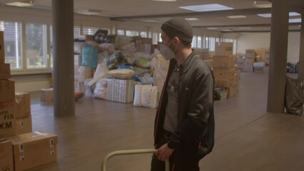 Commentary by volunteer about organizes the collection of humanitarian medical aid to Ukraine. Albisriederstrasse 243, Zurich, Swiss, 11.03.2022 - Powered by Adobe