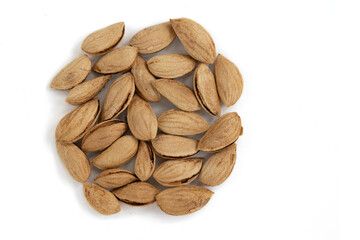pile of unpeeled almonds isolated on white background