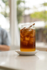 Glass of espresso with orange juice at cafe. Summer Cocktail, Cold brew coffee or black tea. (close up, selective focus)