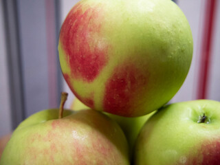 A bunch of juicy red-sided apples, a close-up shot. Ripe fruit.