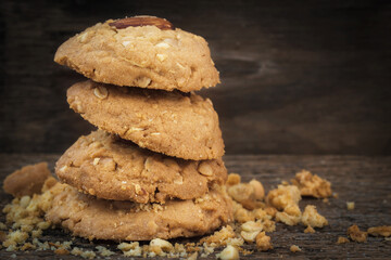 Almond and cashew nut cookies on wooden sheet.