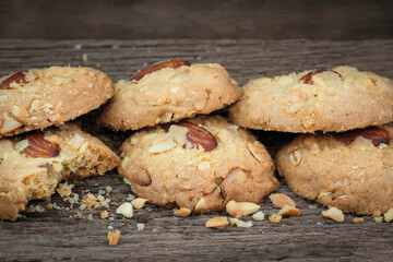 Almond and cashew nut cookies on wooden sheet.