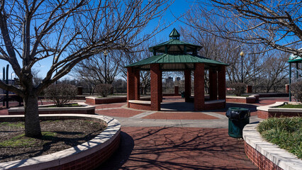 Brick gazebo in South River walk park surrounded by trees