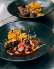 fried meat beef red sauce black plate