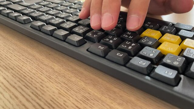 Typing on keyboard. Male hand fingers pressing F5 button key on English - Thai computer black keyboard close up shot. Work from home professional hand press F5 to reload and refresh the page browser