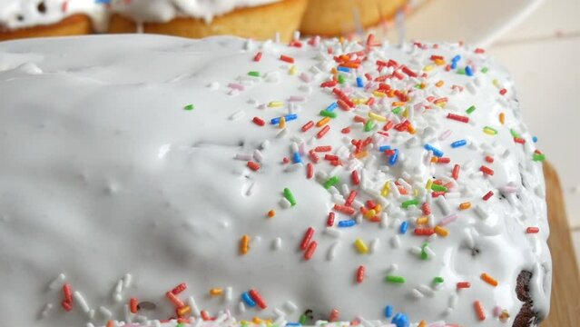 Easter cake with white glaze. Hand sprinkles with multi-colored powder. Easter Traditions in Eastern Europe