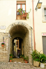 Street between old medieval stone buildings of a historic town in Lazio region, Italy © Giamby/Wirestock Creators