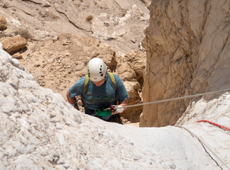 An experienced athlete starts the descent with the equipment for snapping in the mountains of the...