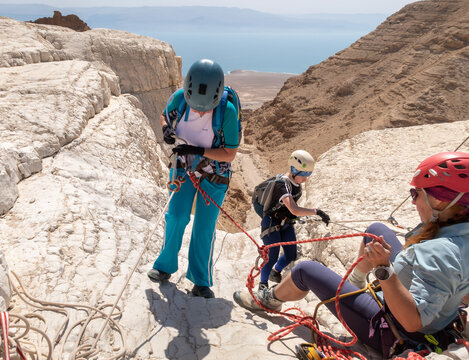 Experienced athletes start the descent with the equipment for snapping in the mountains of the Judean Desert near the Tamarim stream near Jerusalem in Israel