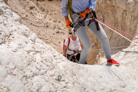 Experienced athletes start the descent with the equipment for snapping in the mountains of the Judean Desert near the Tamarim stream near Jerusalem in Israel