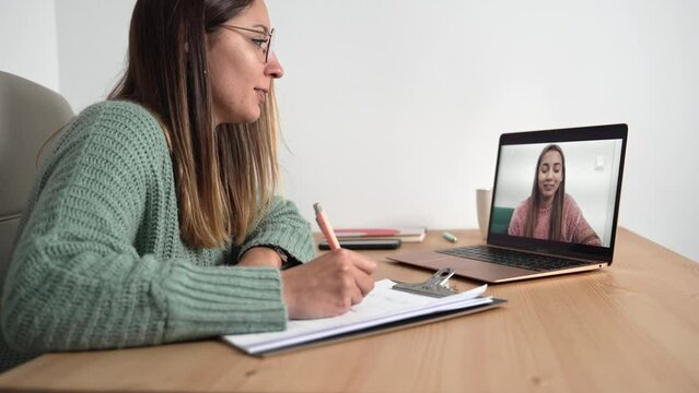 Teenager Girl doing online therapy with psychologist for mental health support . Young woman therapist on video call with young patient 