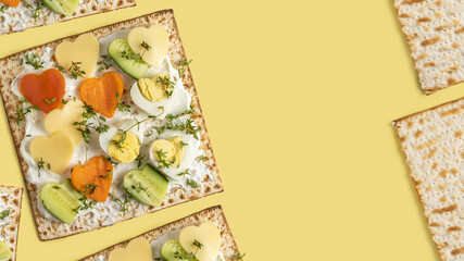 Matzah sandwich with cream cheese, boiled eggs, fresh cucumber, thyme leaves for Israeli breakfast...