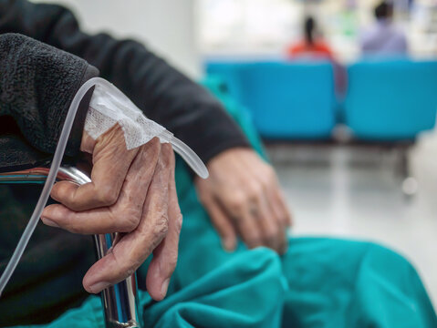 A patient in the hospital with saline intravenous, in Asian elderly man hand., Senior care and treatment of the disease concept.