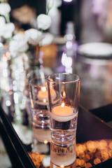 Fototapeta na wymiar bohemian boho decor with candles on the wedding banquet table