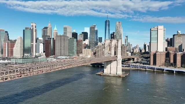 aerial on East River toward Brooklyn Bridge, Manhattan skyline Freedom Tower in New York City