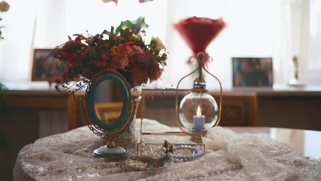 Interior shot of small boudoir dressing table with small mirror and flowers. women's fees concept. High quality FullHD footage
