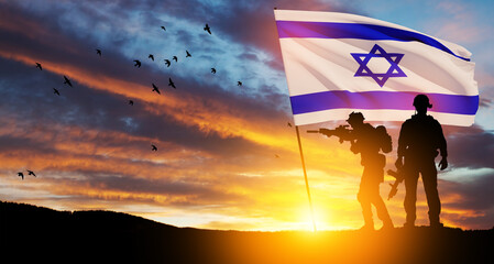 Silhouettes of soldiers with Israel flag and flying birds against the sunrise in the desert....