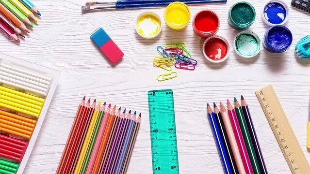 School supplies on a white background, paints and brushes