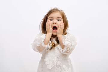 portrait of little surprised blonde princess girl in white dress with crown on head on white background, for children's advertising, copy space