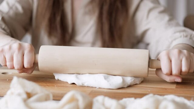 Handcraft woman master modeling cold porcelain, hands with rolling pin, creative workshop, Girl sculpts from porcelain, hobby for the soul scandinavian and boho style interior decor