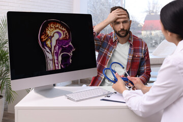 Man having appointment with neurologist in clinic - obrazy, fototapety, plakaty