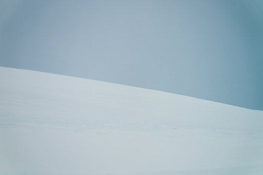 A narrow borderline of sky and snow mountain in the Antarctica
