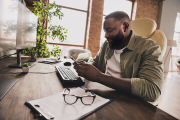 Profile portrait of happy hacker sit chair use telephone chatting texting workstation indoors