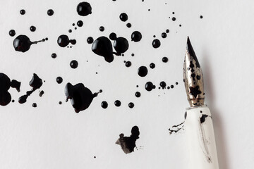 fountain pen and ink blots on a white sheet of paper