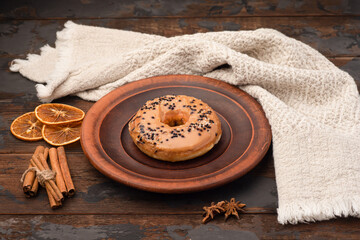 Donut, donut with sprinkles, on a wooden background.