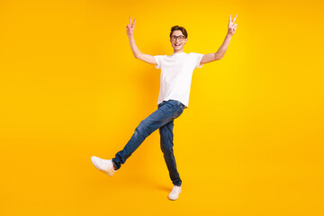 Fototapeta na wymiar Full body profile side photo of young man good mood show fingers peace cool v-symbol isolated over yellow color background