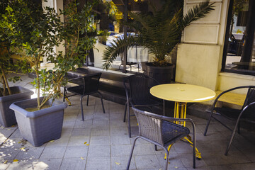EMPTY TABLE TOP IN CITY RESTAURANT. The table set next to the window with round table on the floor