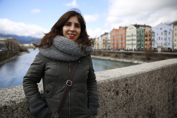 A young woman in the colorful house near the river in the city of Innsbruck. Austria