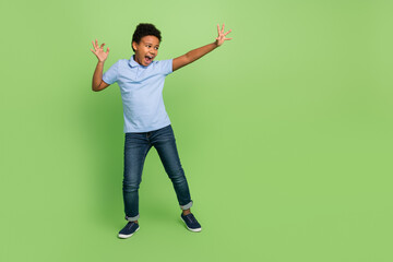 Full length body size view of two attractive funky cheerful pre-teen boy dancing having fun fooling isolated over green color background