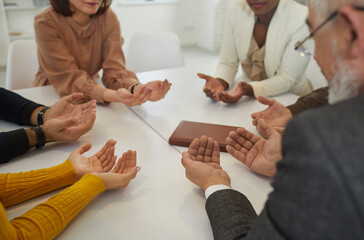 People who believe in God praying together. Group of different young and senior multiracial...