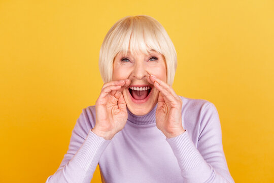 Photo of cheerful lovely lady arms near mouth scream advertising promotion discount isolated over yellow color background