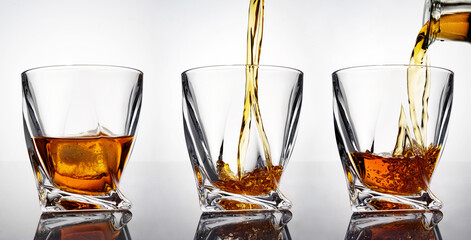 luxury whiskey in a crystal glass with reflection, isolated on white background