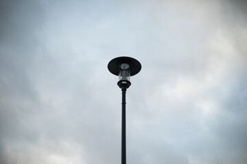 Street lighting in park. Pillar against sky.