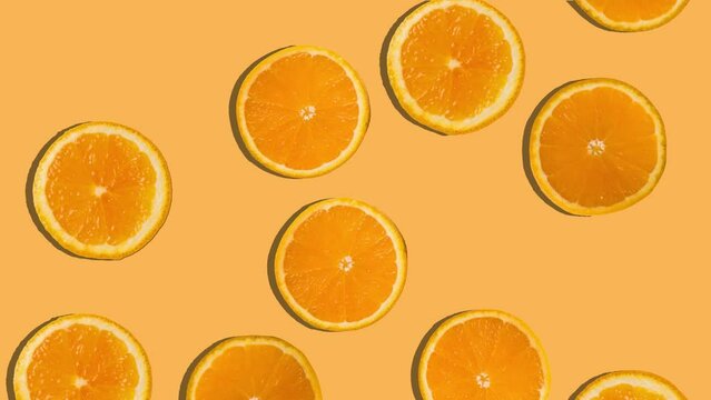 Background of orange slices falling. Fresh fruit. Loop. 4K.