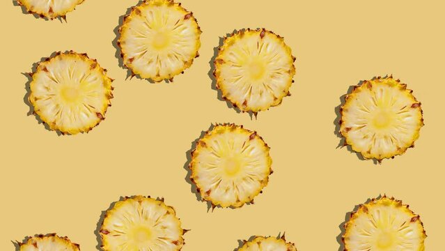Background of falling pineapple slices. Fresh fruit. Loop. 4K.