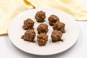 Chocolate with Hazelnut Chips. Special chocolates on a white background. close up