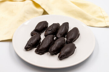 Dark chocolate with coconut filling. Special chocolates on a white background. close up