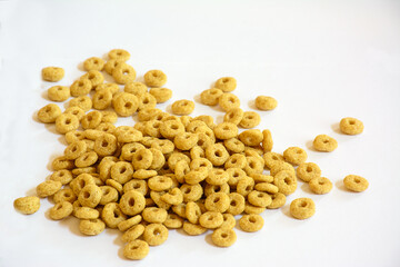 Dry breakfast corn rings on a white background
