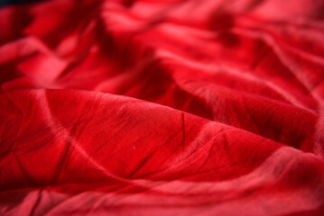 Wrinkled red fabric. Bright colorful background for design.