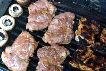Chicken and mushrooms cooked on the barbecue.